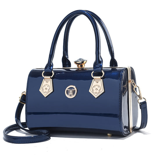 Blue handbag with gold accents on a white background