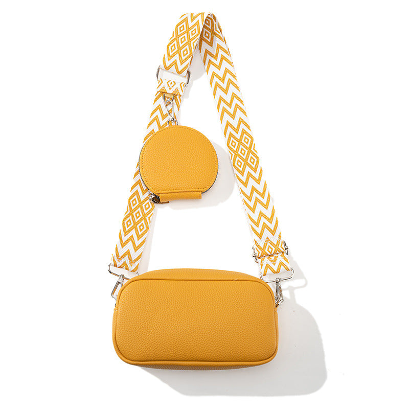 Women's casual crossbody bag in yellow with round zip pocket and long chevron strap