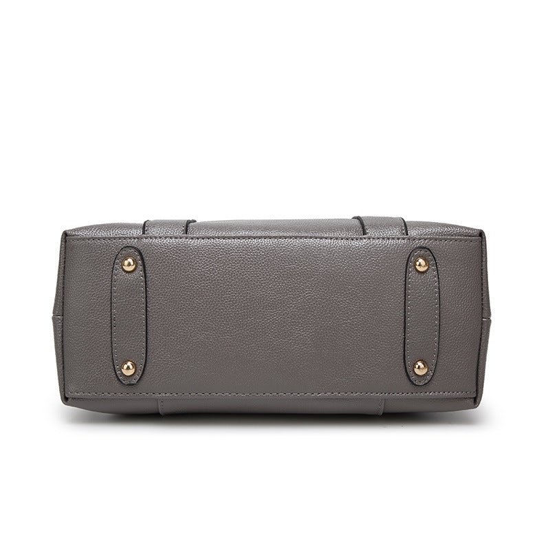 Grey PU leather tote handbag with front panel, top handles, and gold stud accents