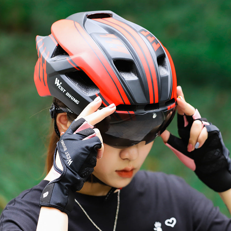 Cycling helmet with integrated goggles, orange and black stripes worn