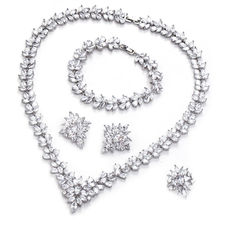 Silver zircon floral jewelry set with necklace, bracelet, two earrings, and ring