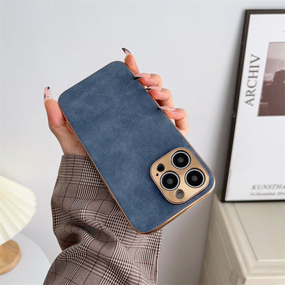 Hand holding a blue phone case with gold accents against a neutral background