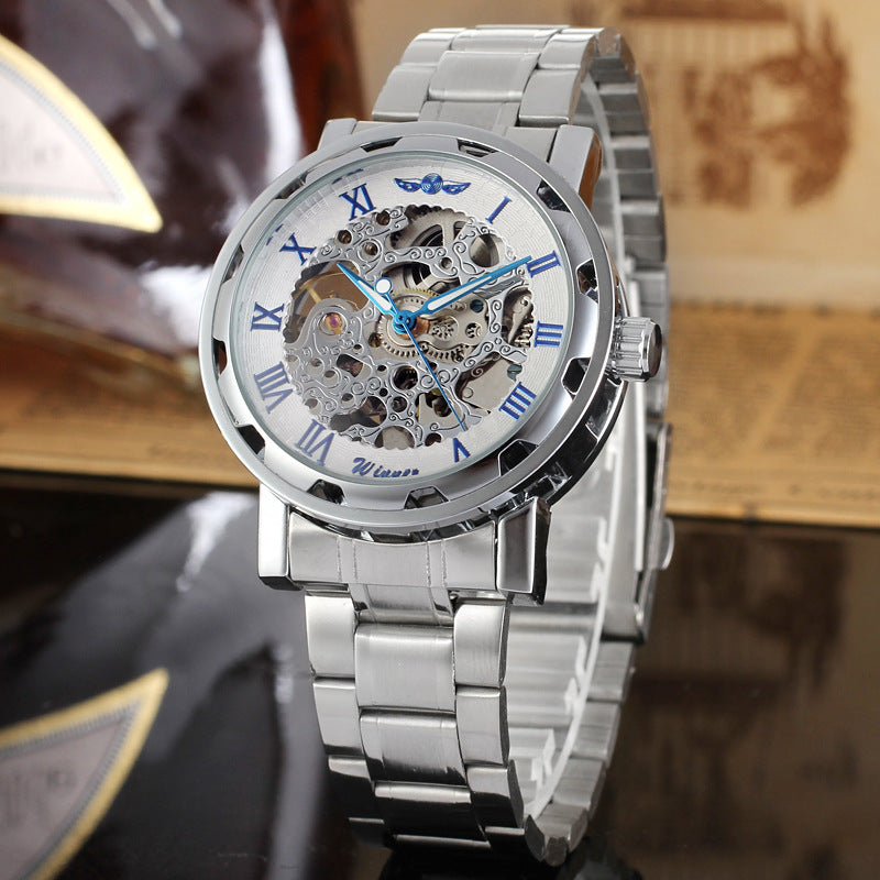 Mechanical skeleton watch with blue hands and visible gears on a white dial