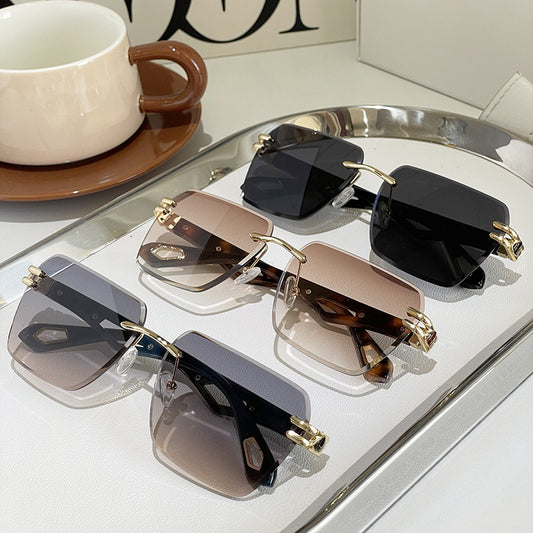 Set of sunglasses with different lens colors on a reflective surface.