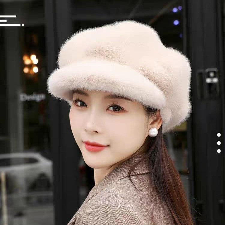 Woman wearing a fluffy beige hat with a blurred indoor background