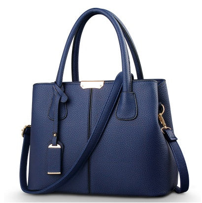 Dark blue leather shoulder tote bag with gold-tone hardware, top handles, and crossbody strap