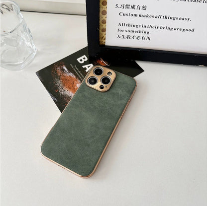 Green phone case on a white surface with a magazine and glass in the background