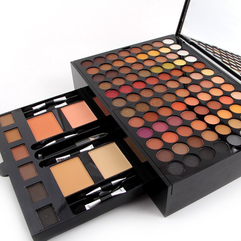 Open eyeshadow palette with multicolor pan grid and two blush shades in a black case
