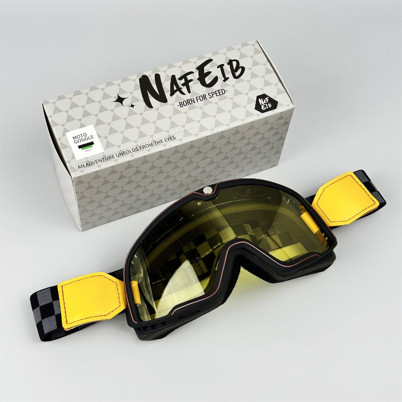 Goggles with yellow straps and a branded box on a light gray background