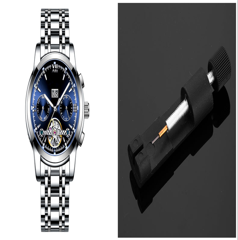 Silver wristwatch with blue face and battery on a black background