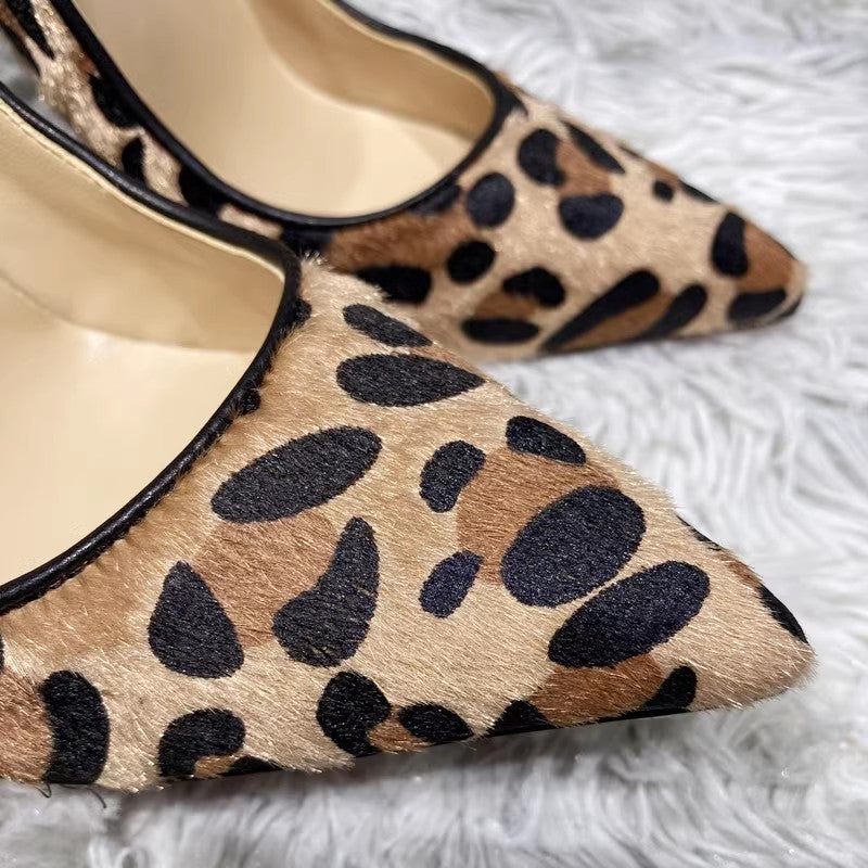 Leopard print high-heeled shoes on a white surface