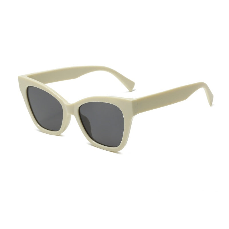 Light beige sunglasses with gray-tinted lenses and cat-eye silhouette