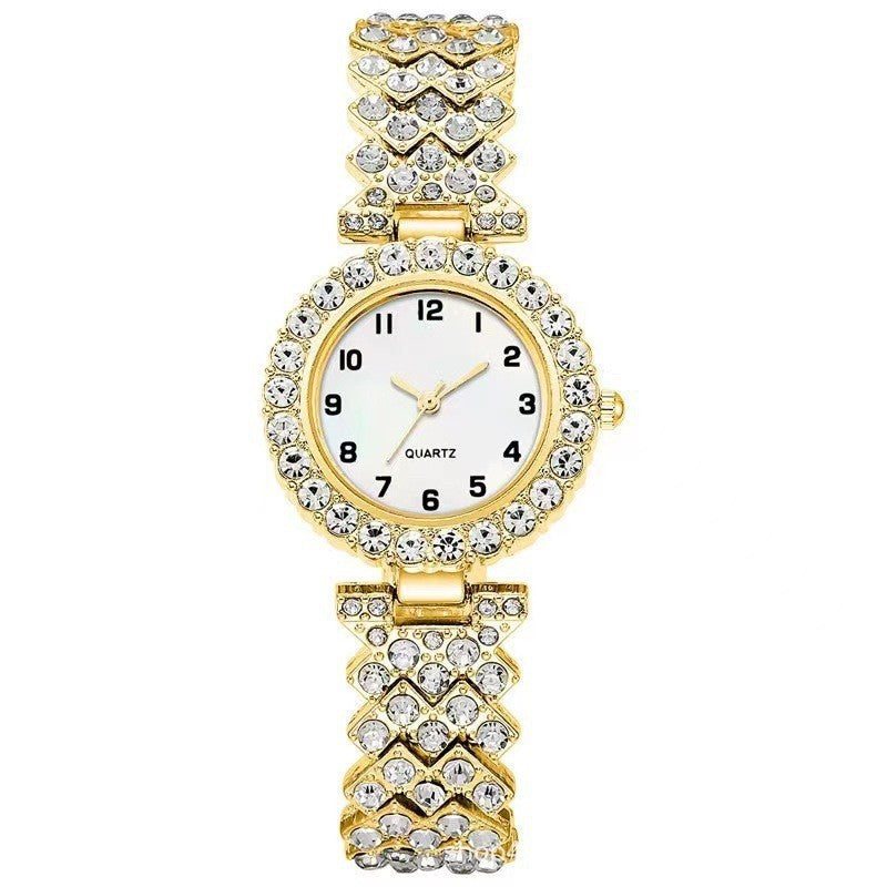 Gold-tone rhinestone-style watch with white dial and heart-link band