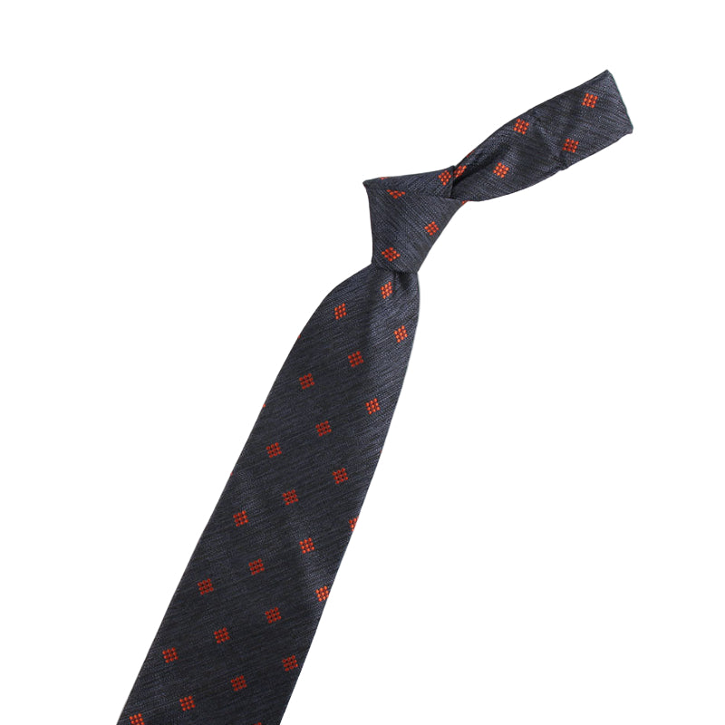 Black tie with red pattern and two decorative pins on a white background