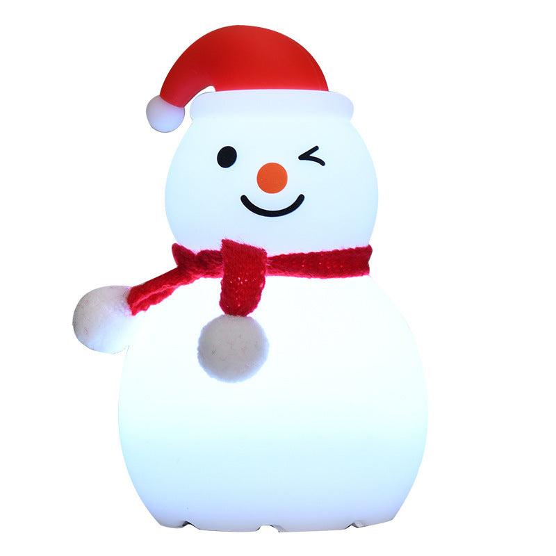 Blue-glowing snowman night light with red hat and red scarf, smiling face