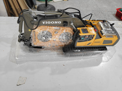 Yellow RC excavator toy packed in clear wrap with protected metal arm and cab