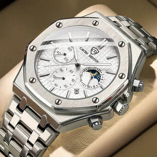 Silver watch with detailed face on a wrist against a beige background