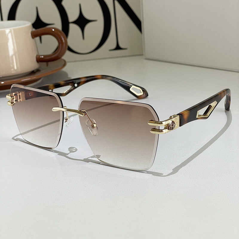 Square sunglasses with amber-brown gradient lenses, tortoise-style arms, gold-tone accents