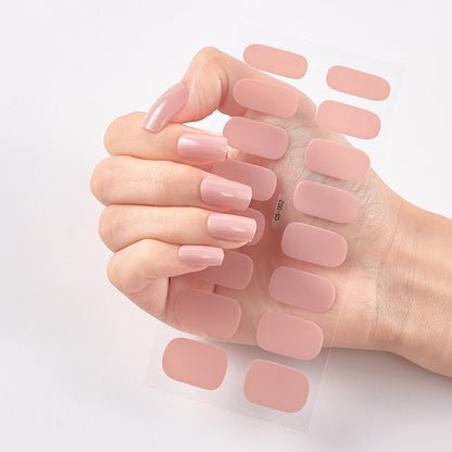 Hand holding pink nail polish samples on a light background