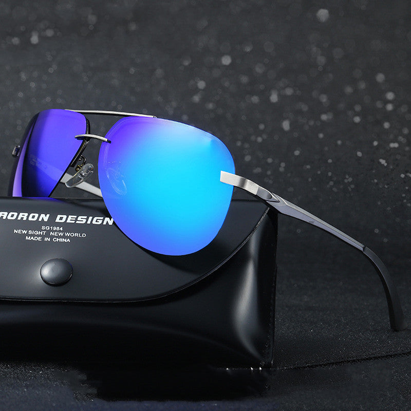 Sunglasses with blue lenses and silver frame on a black case against a dark background