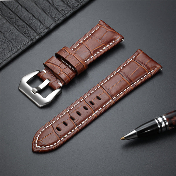 Brown leather watch strap with metal buckle and white contrast stitching.