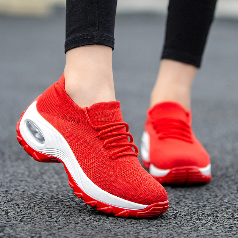 Red knit lace-up athletic shoes with white sole and oval air window detail