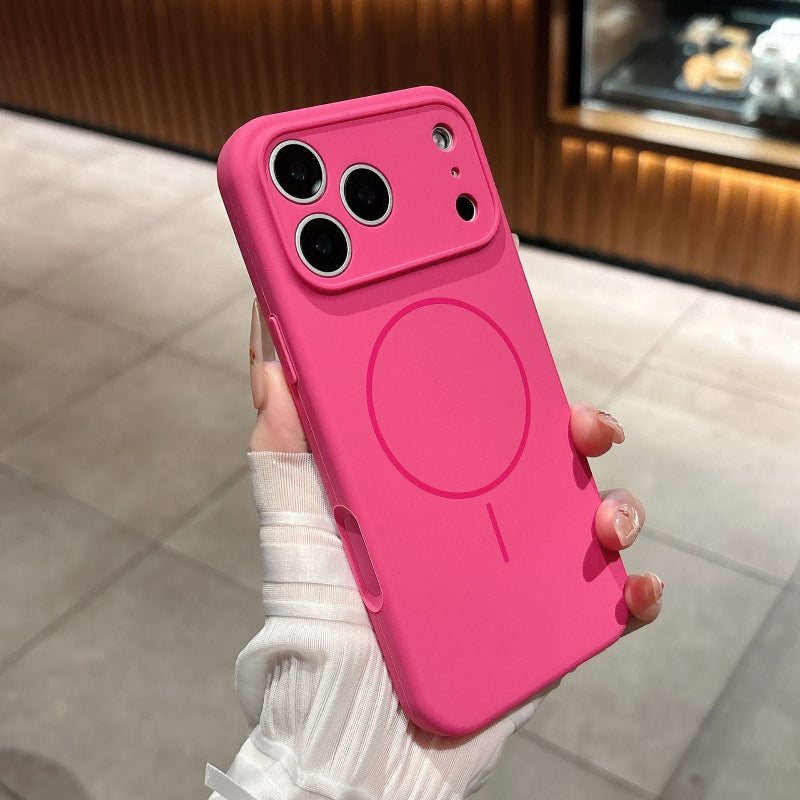 Pink phone case with a wireless charging design held by a person.