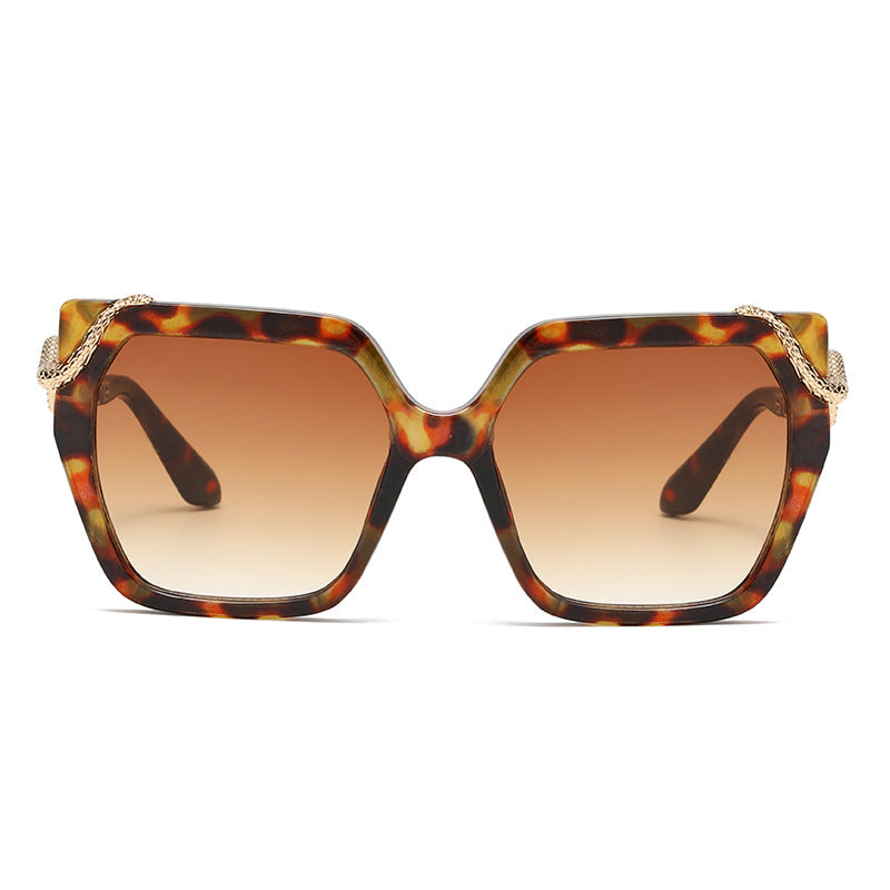 Sunglasses with tortoiseshell frame and brown lenses on a white background