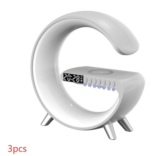 White G-shaped lamp with digital clock, speaker controls and wireless phone charging pad