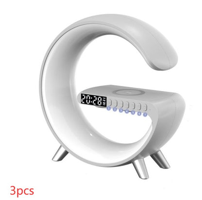 White G-shaped lamp with digital clock, speaker controls and wireless phone charging pad