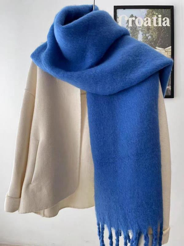Women's wool-like scarf, blue, fringed ends, folded over a display top for a wide wrap