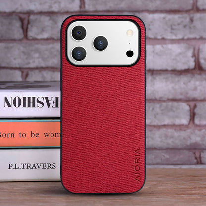 Red phone case with 'ALORIA' branding on a brick wall background