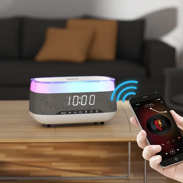 White and gray Bluetooth speaker with LED display and smartphone controlling playback