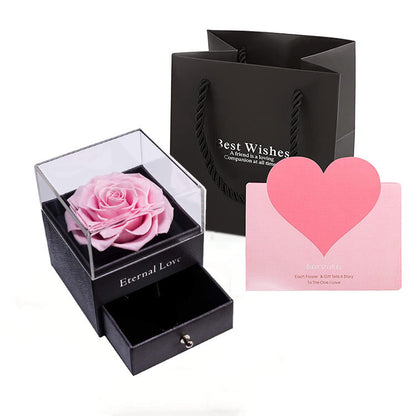Acrylic jewelry gift box with pink preserved rose in a clear top display