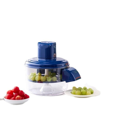 Blue manual juicer with grapes and cherry tomatoes on a white background