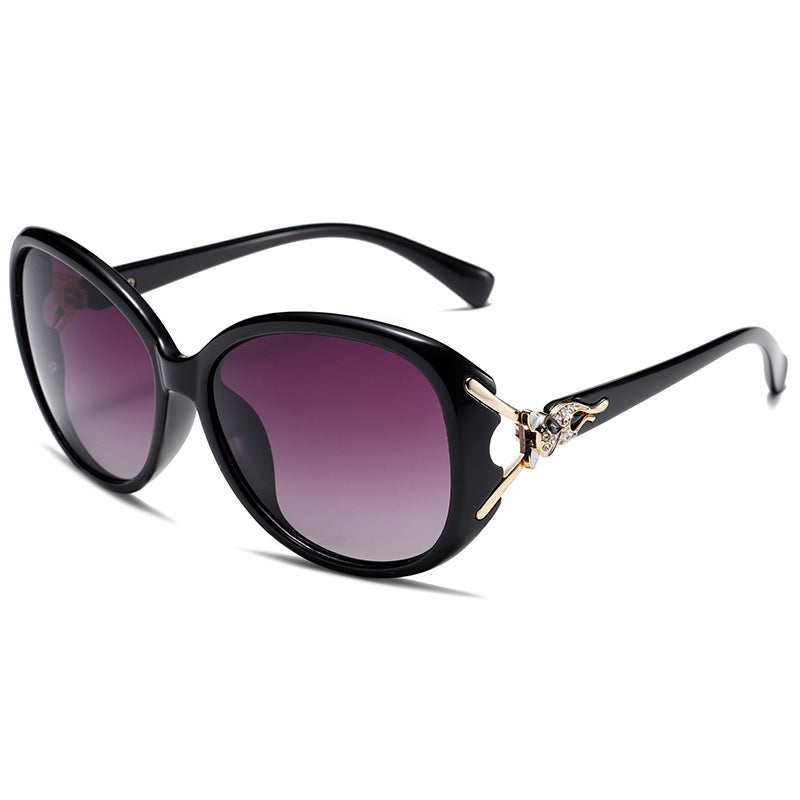 Black sunglasses with purple gradient lenses on a white background