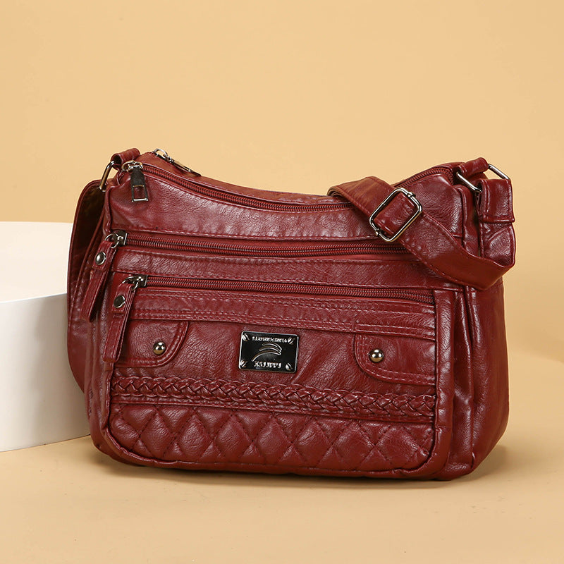 Brown leather handbag with braided detail on a beige background