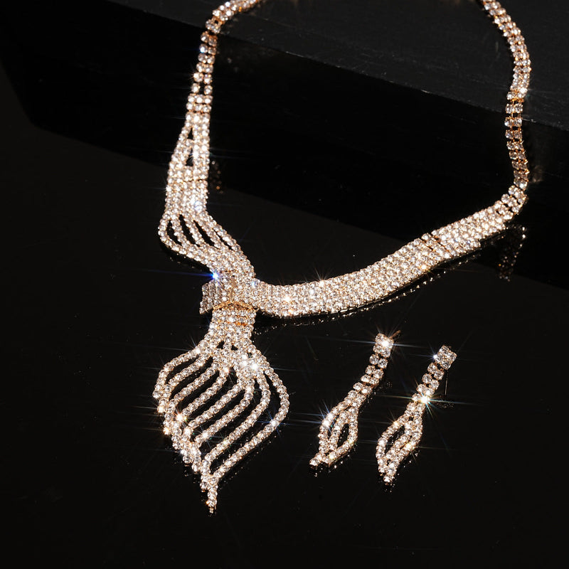 Silver-tone rhinestone choker necklace with teardrop pendant and drop earrings