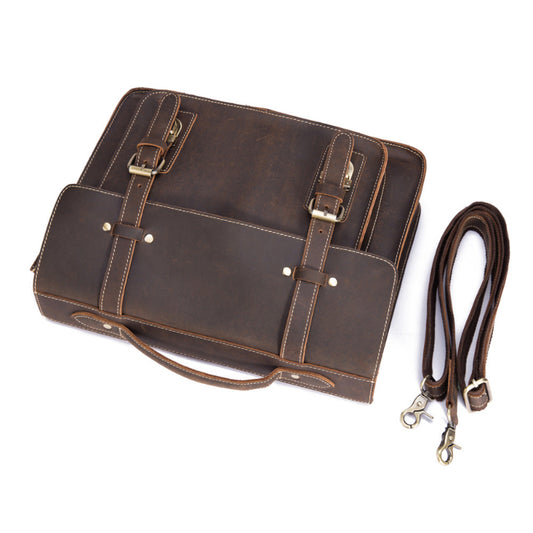 Brown leather bag with strap on a white background