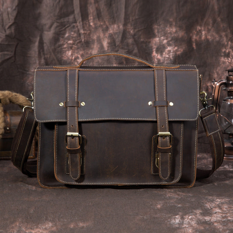 Coffee-brown leather handbag with front flap, buckle straps, and stitched handles