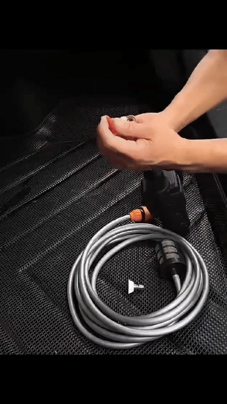 Cordless pressure washer with coiled hose and hand connecting fitting