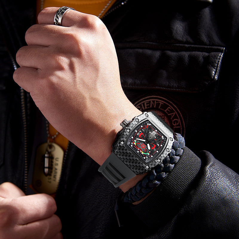 Men's quartz wristwatch on wrist, black case with gray silicone strap and red dial.