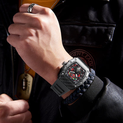 Men's quartz wristwatch on wrist, black case with gray silicone strap and red dial.