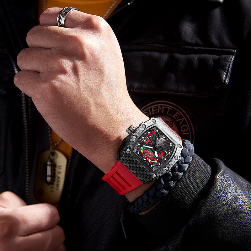 Men's quartz wristwatch on wrist, black case with red silicone strap and red dial.