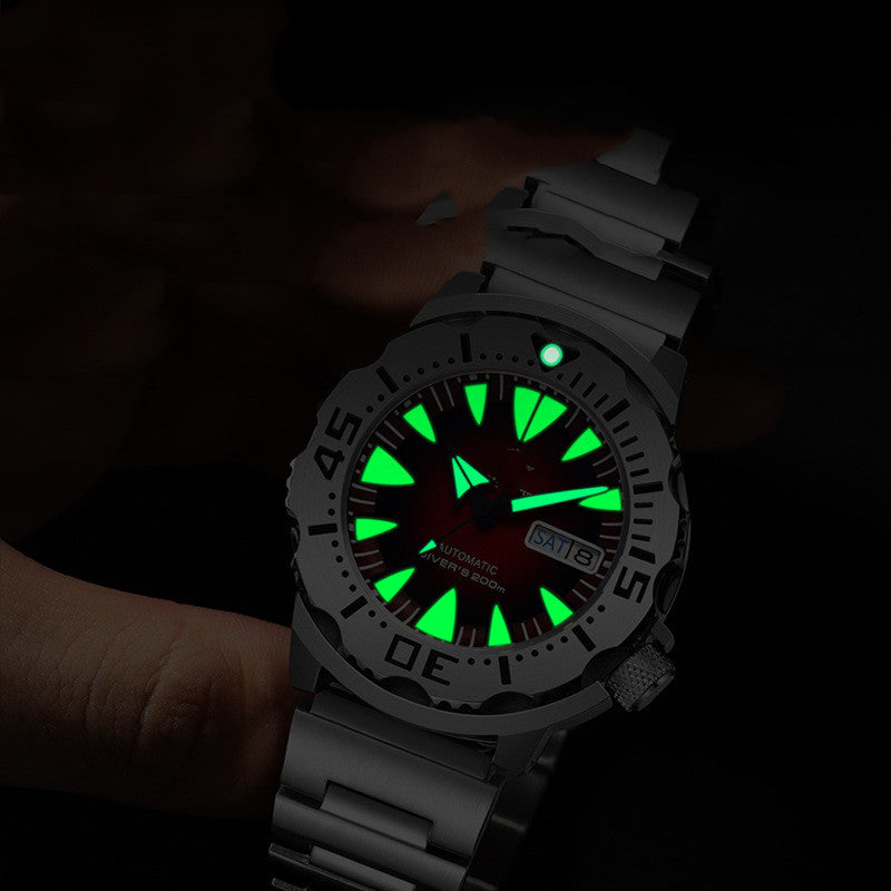 Black diver watch with green luminous dial and date window on wrist