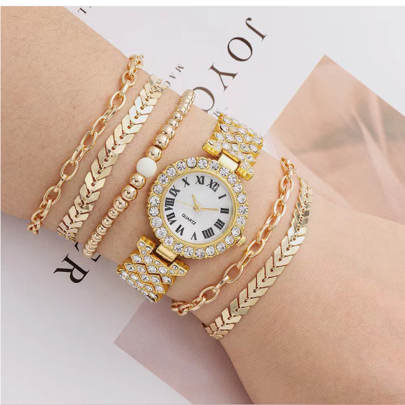 Gold-toned crystal watch with stacked bracelet bangles and pearl accents