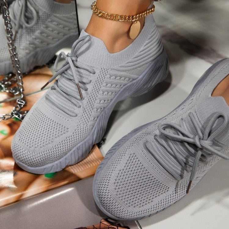 Light gray thick-sole dad sneakers with lace-up front and cushioned chunky sole