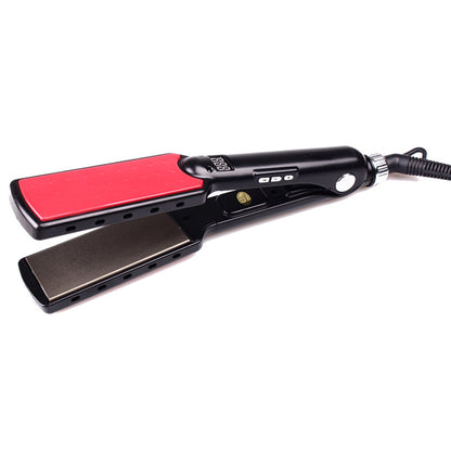 Hair straightener with red heating plate on a white background