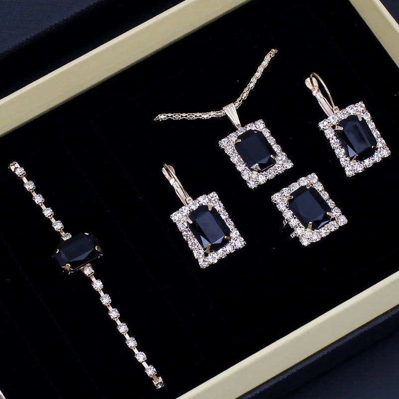 Rhinestone jewelry set in box: tennis bracelet and four square drop earrings with dark blue stones
