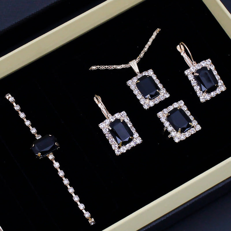 Rhinestone jewelry set in box: long tennis bracelet and five square drop earrings with dark blue stones
